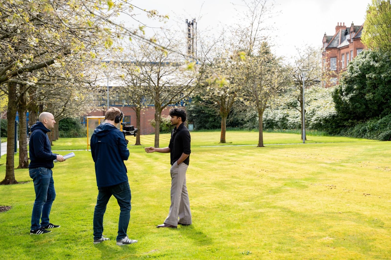 Goutham being filmed for an interview on the lawn at Ulster University's Magee campus.
